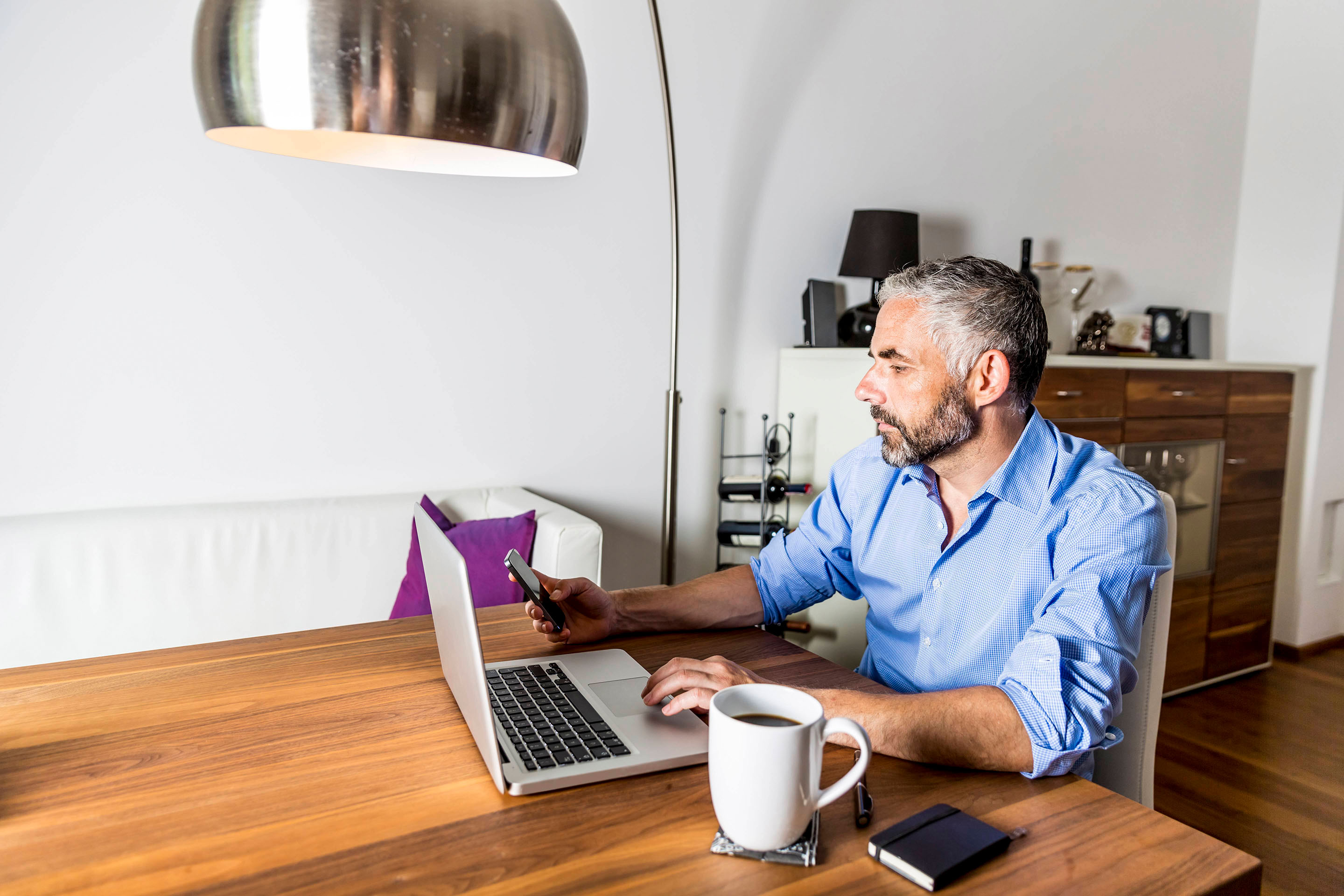 Portrait of businessman working with laptop at home office 