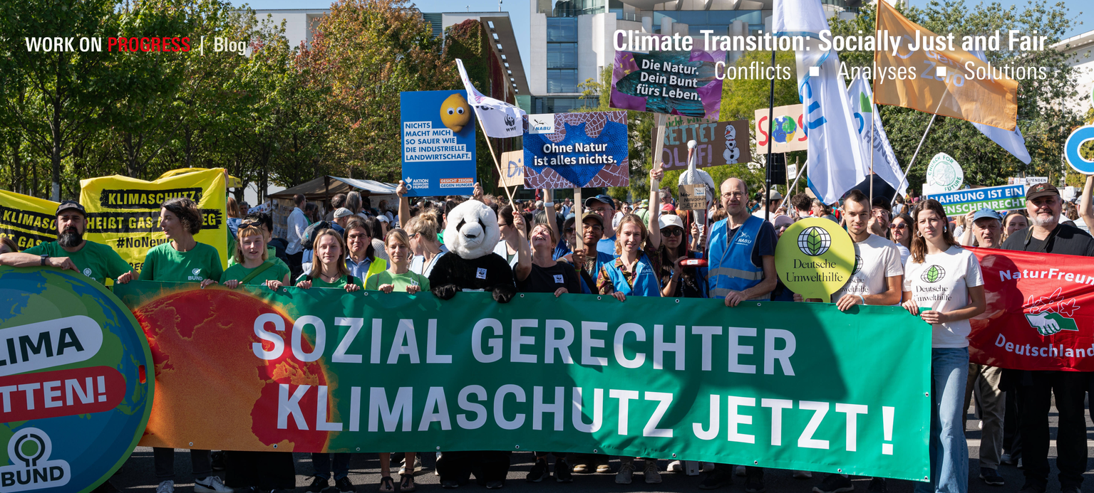 Demonstrators display a poster reading “Socially just climate protection now!” as well as other posters.